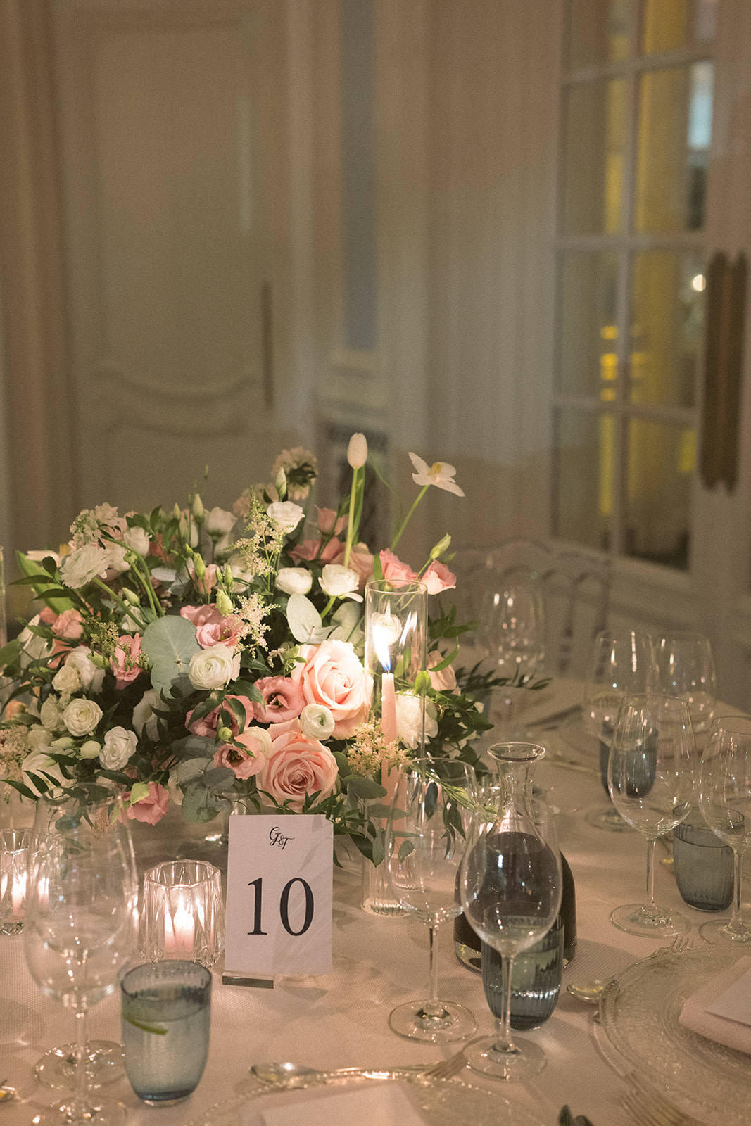 photograph of a luxury wedding at The Savoy in London with romantic floral styling and candlelight by Rachel Takes Pictures with Elegante by Michelle J