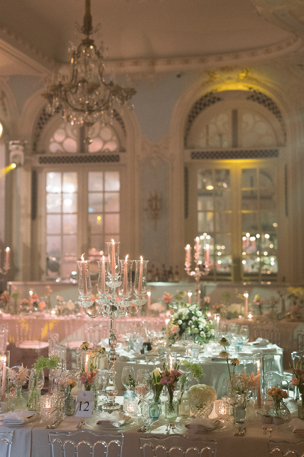photograph of a luxury wedding at The Savoy in London with romantic floral styling and candlelight by Rachel Takes Pictures with Elegante by Michelle J