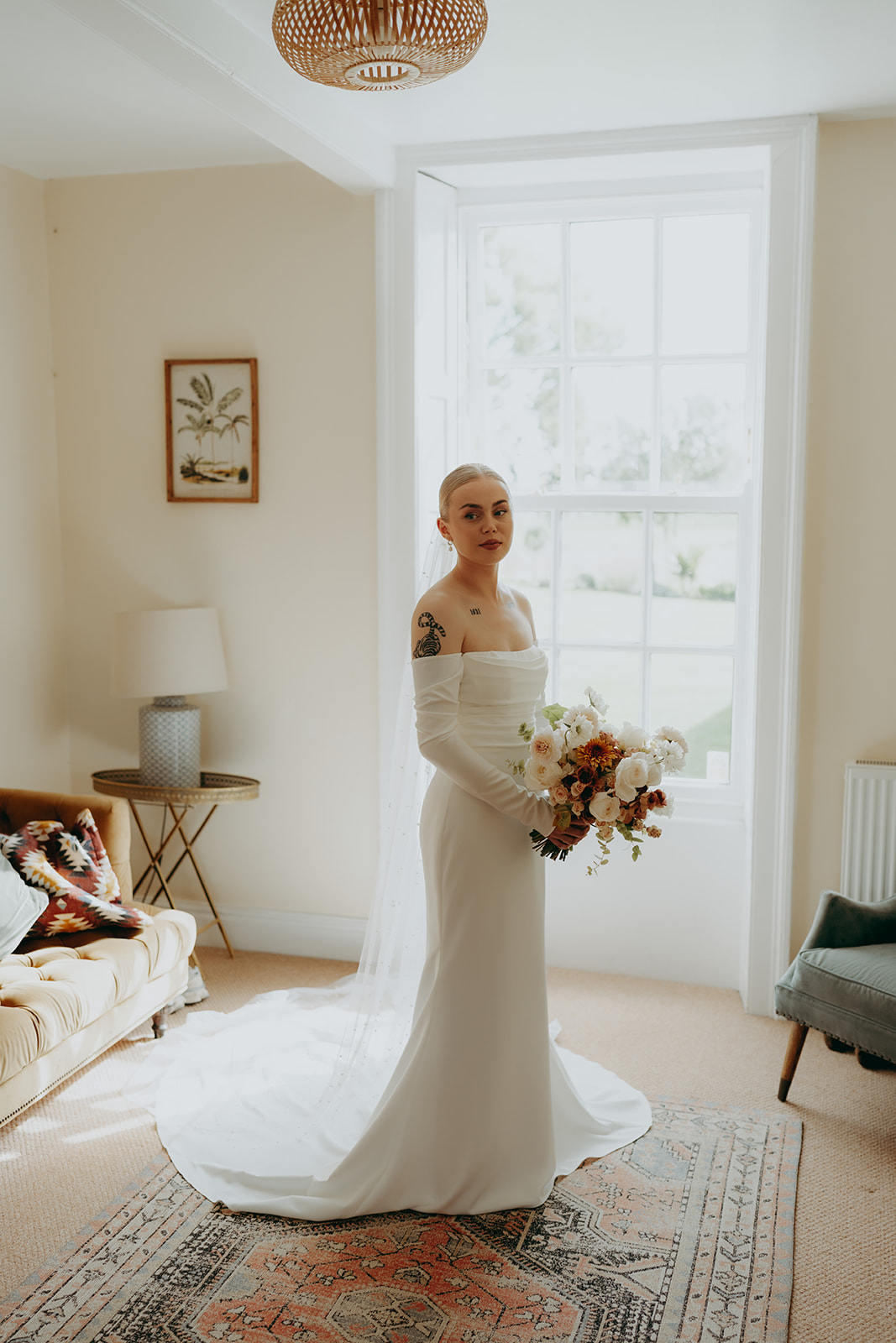 Real wedding at Thirsk Barn near Harrogate with a groom in a dark green suit and bride in a slim fitting dress with long gloves. Image by Yorkshire wedding photographer Joss Denham Photography