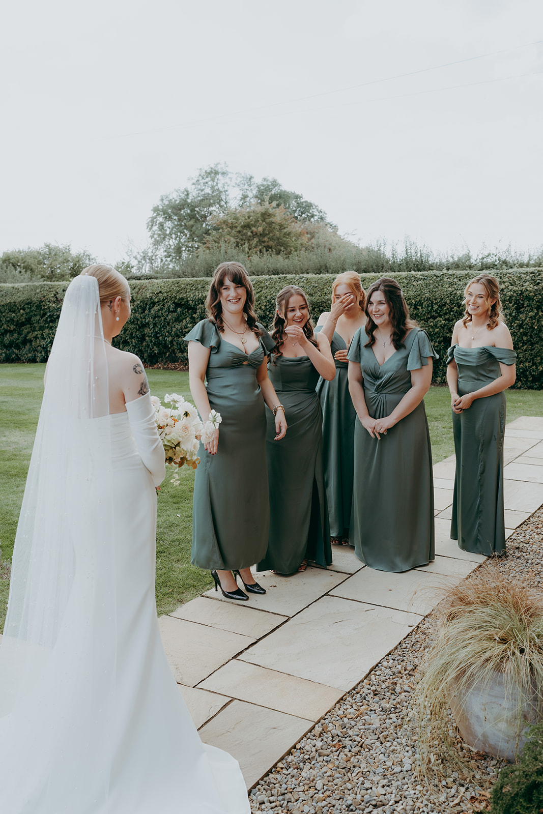 Real wedding at Thirsk Barn near Harrogate with a groom in a dark green suit and bride in a slim fitting dress with long gloves. Image by Yorkshire wedding photographer Joss Denham Photography