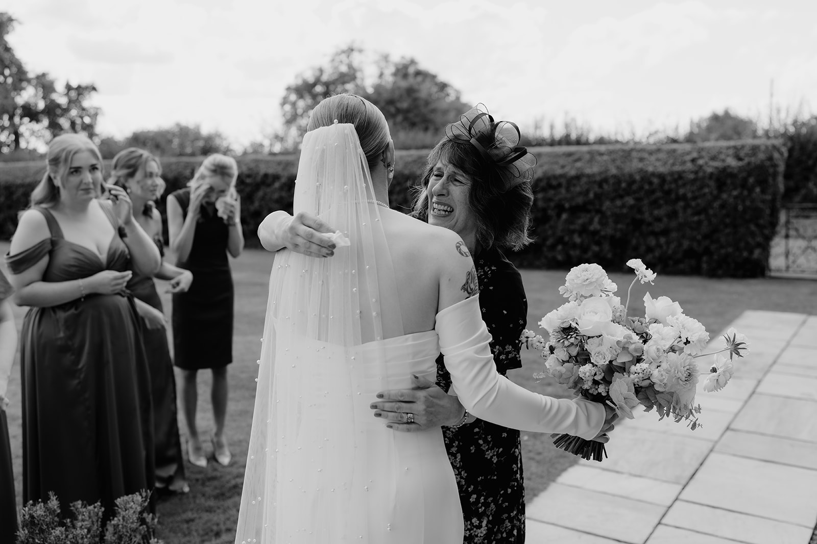 Real wedding at Thirsk Barn near Harrogate with a groom in a dark green suit and bride in a slim fitting dress with long gloves. Image by Yorkshire wedding photographer Joss Denham Photography