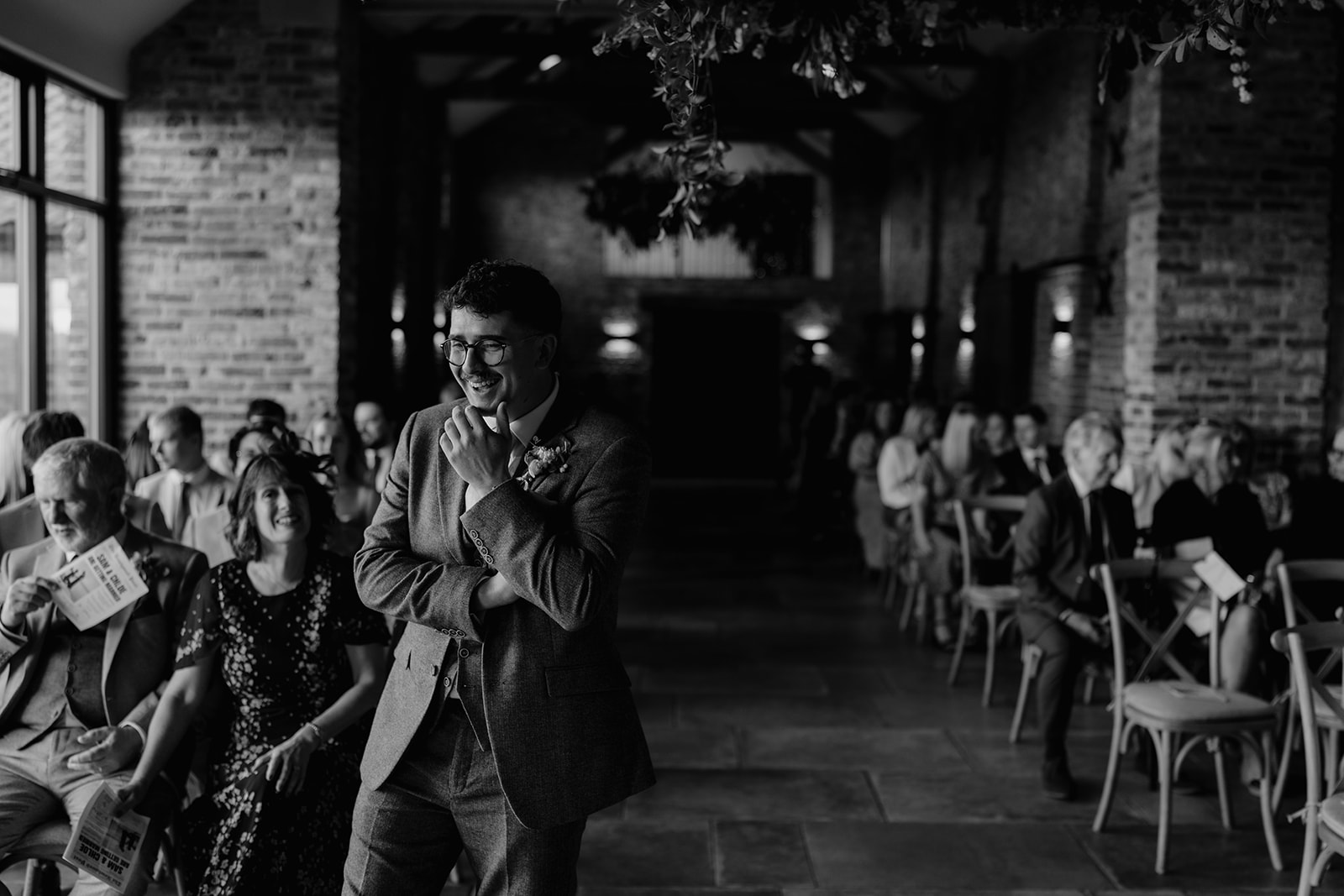 Real wedding at Thirsk Barn near Harrogate with a groom in a dark green suit and bride in a slim fitting dress with long gloves. Image by Yorkshire wedding photographer Joss Denham Photography