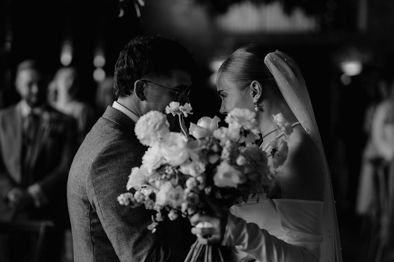 Real wedding at Thirsk Barn near Harrogate with a groom in a dark green suit and bride in a slim fitting dress with long gloves. Image by Yorkshire wedding photographer Joss Denham Photography