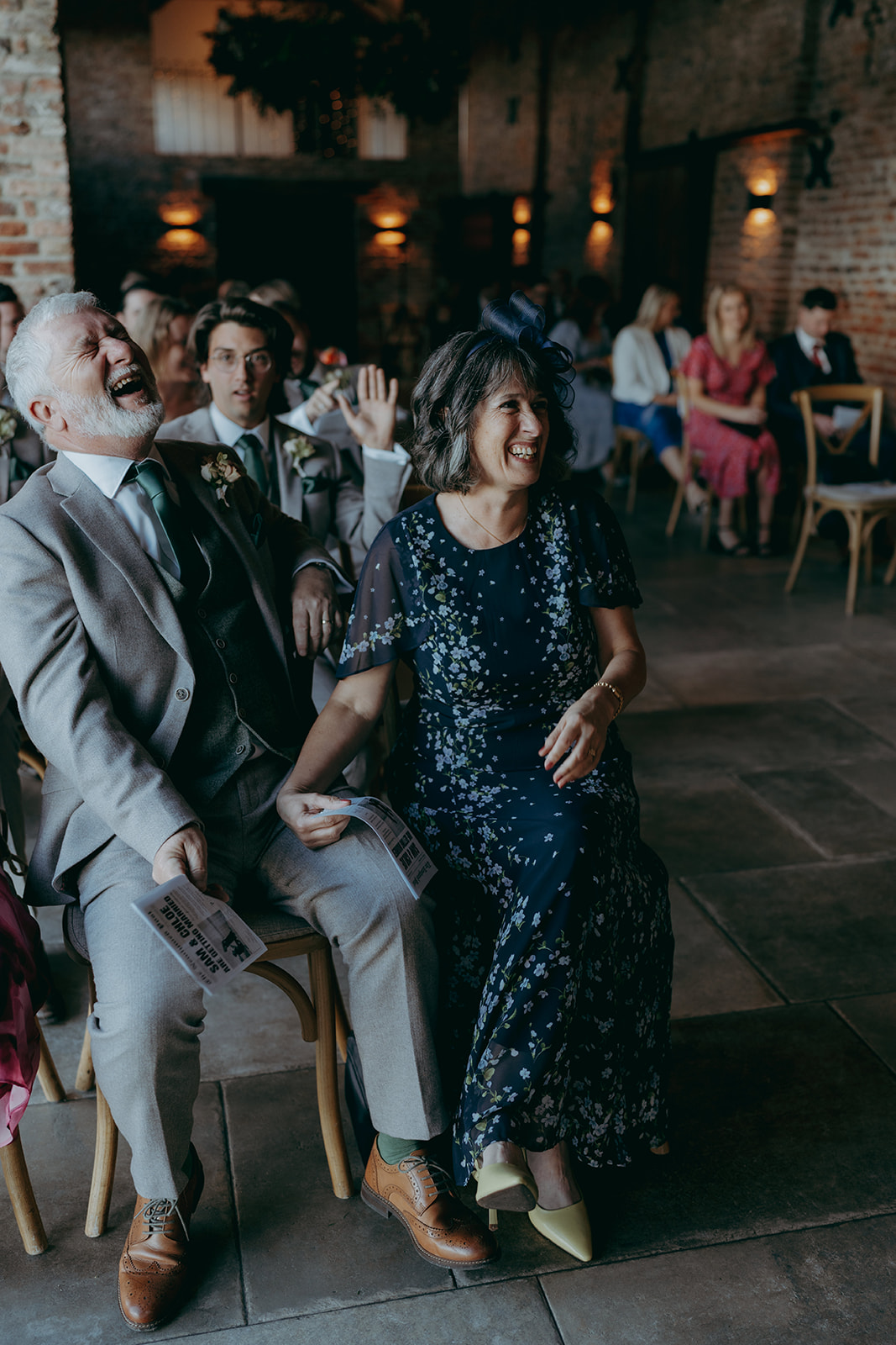 Real wedding at Thirsk Barn near Harrogate with a groom in a dark green suit and bride in a slim fitting dress with long gloves. Image by Yorkshire wedding photographer Joss Denham Photography