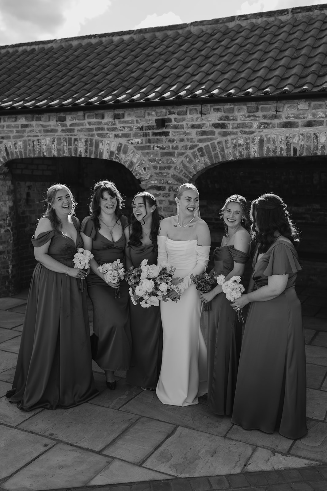Real wedding at Thirsk Barn near Harrogate with a groom in a dark green suit and bride in a slim fitting dress with long gloves. Image by Yorkshire wedding photographer Joss Denham Photography