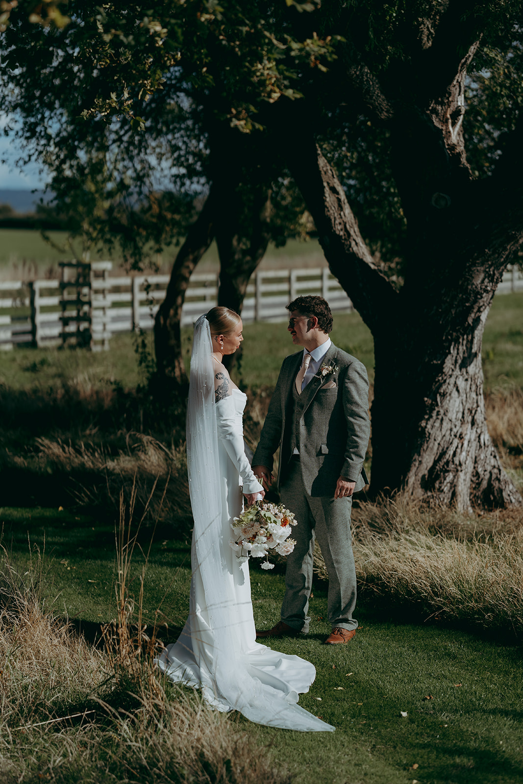 Real wedding at Thirsk Barn near Harrogate with a groom in a dark green suit and bride in a slim fitting dress with long gloves. Image by Yorkshire wedding photographer Joss Denham Photography