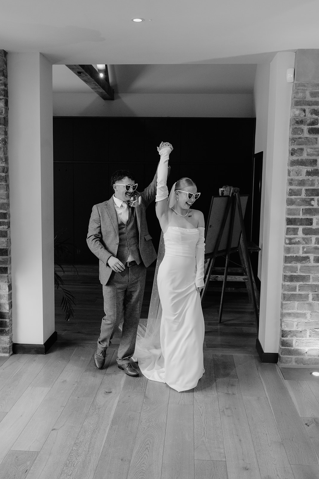 Real wedding at Thirsk Barn near Harrogate with a groom in a dark green suit and bride in a slim fitting dress with long gloves. Image by Yorkshire wedding photographer Joss Denham Photography