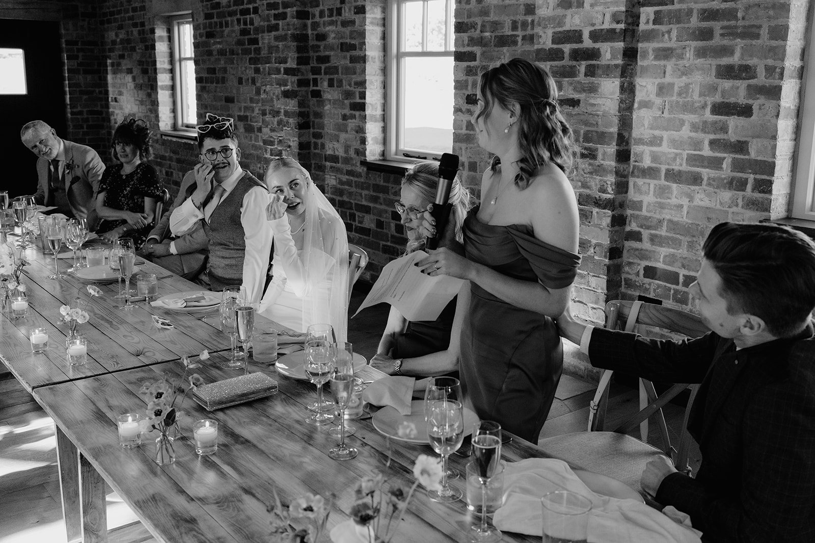 Real wedding at Thirsk Barn near Harrogate with a groom in a dark green suit and bride in a slim fitting dress with long gloves. Image by Yorkshire wedding photographer Joss Denham Photography