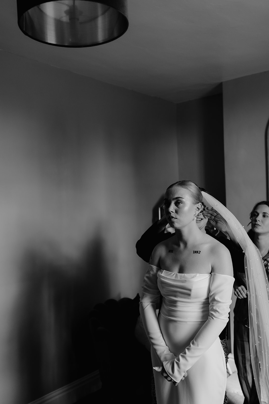 Real wedding at Thirsk Barn near Harrogate with a groom in a dark green suit and bride in a slim fitting dress with long gloves. Image by Yorkshire wedding photographer Joss Denham Photography
