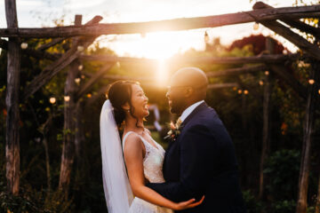 Bride and groom with arms around each other at golden hour | Hannah Hall Photography
