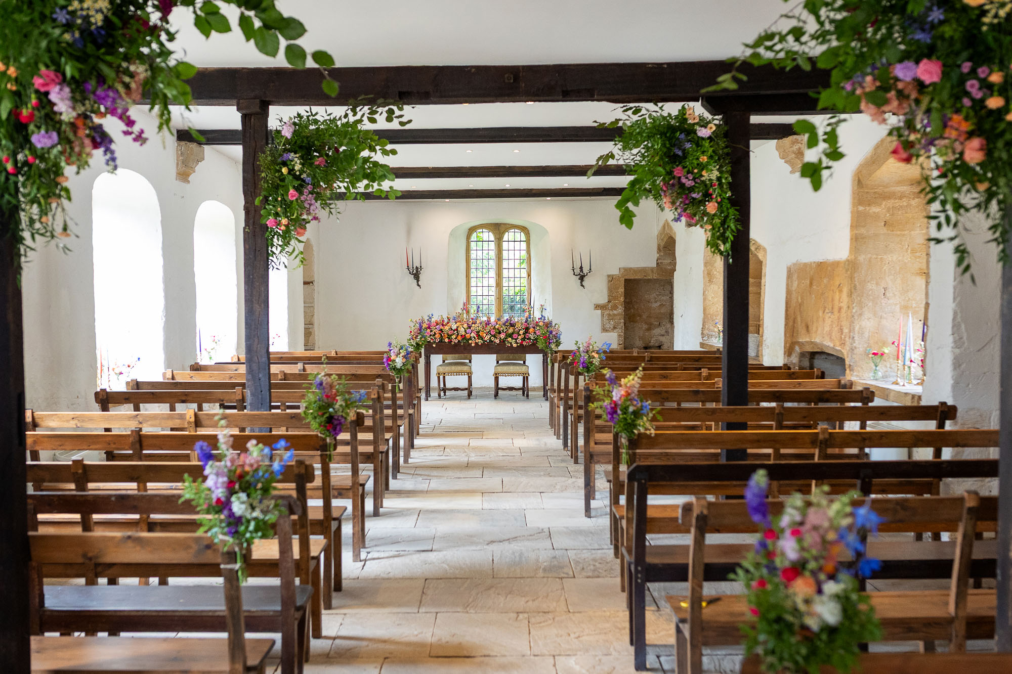 Photographs from an Indian wedding at Brympton House with really colourful flowers and a focus on human connection and love. By Martin Dabek Photography from Bristol