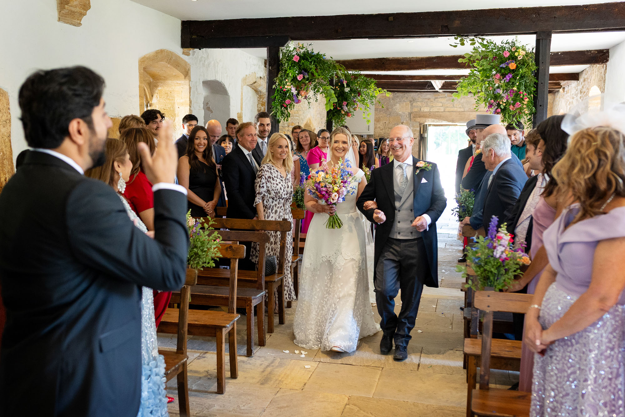 Photographs from an Indian wedding at Brympton House with really colourful flowers and a focus on human connection and love. By Martin Dabek Photography from Bristol