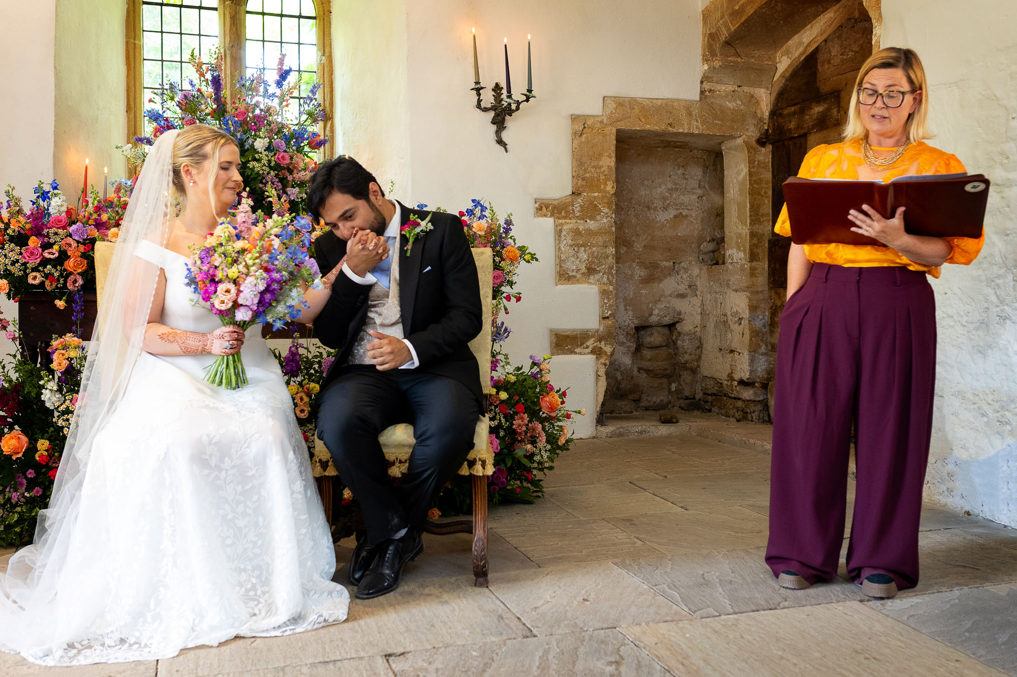 Photographs from an Indian wedding at Brympton House with really colourful flowers and a focus on human connection and love. By Martin Dabek Photography from Bristol