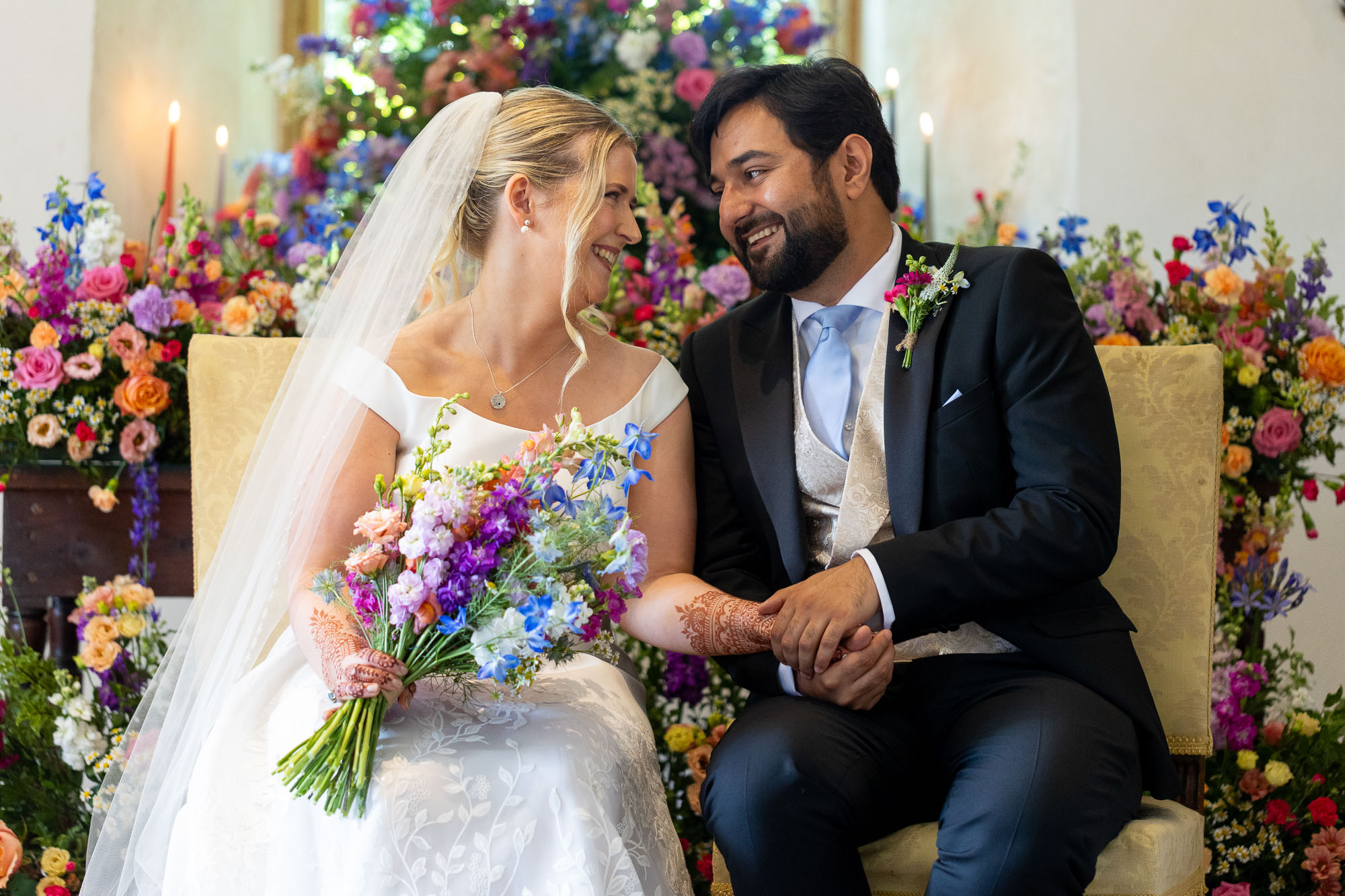 Photographs from an Indian wedding at Brympton House with really colourful flowers and a focus on human connection and love. By Martin Dabek Photography from Bristol