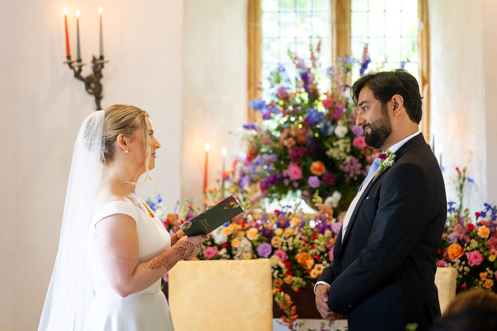 Photographs from an Indian wedding at Brympton House with really colourful flowers and a focus on human connection and love. By Martin Dabek Photography from Bristol