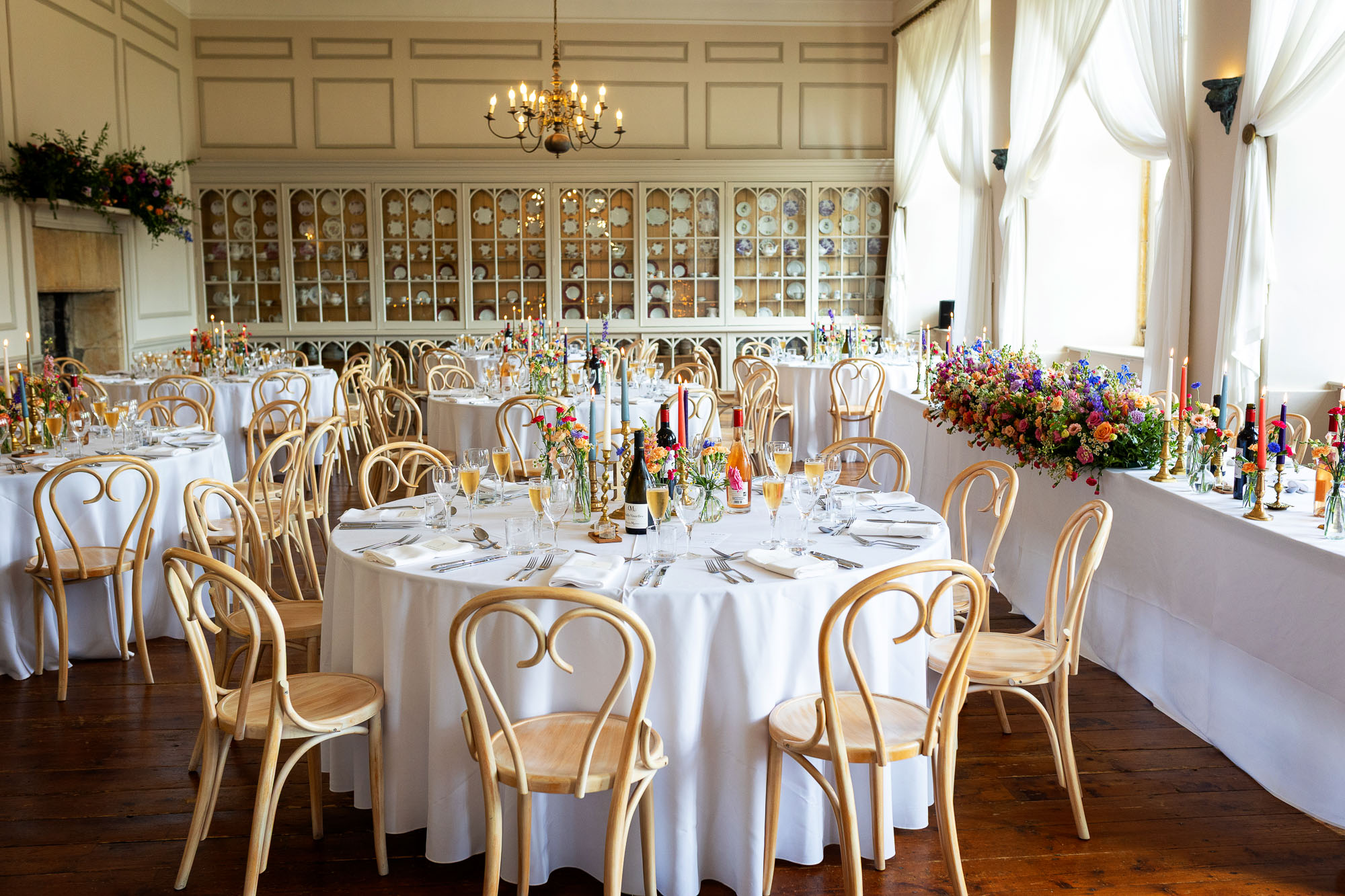Photographs from an Indian wedding at Brympton House with really colourful flowers and a focus on human connection and love. By Martin Dabek Photography from Bristol