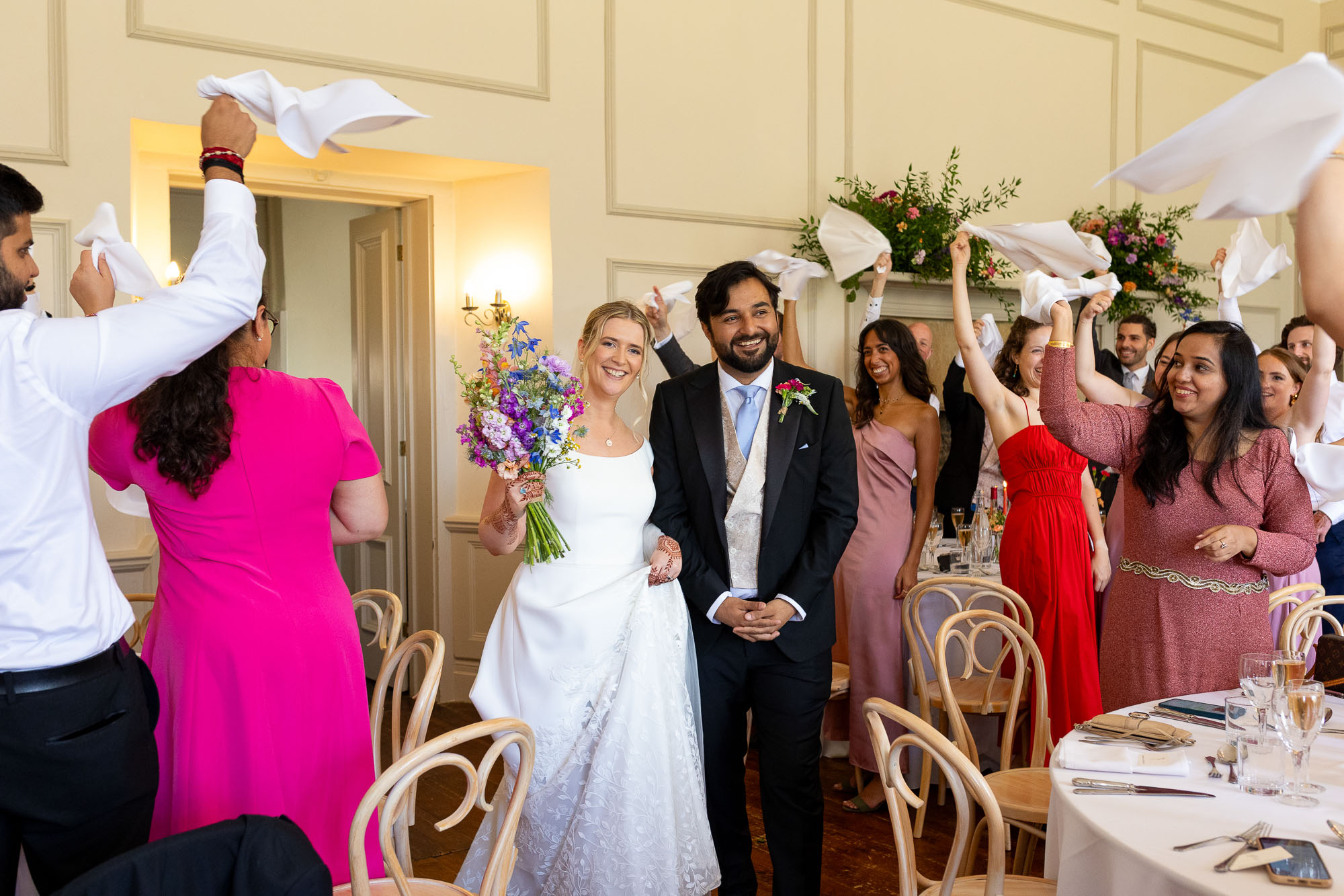 Photographs from an Indian wedding at Brympton House with really colourful flowers and a focus on human connection and love. By Martin Dabek Photography from Bristol