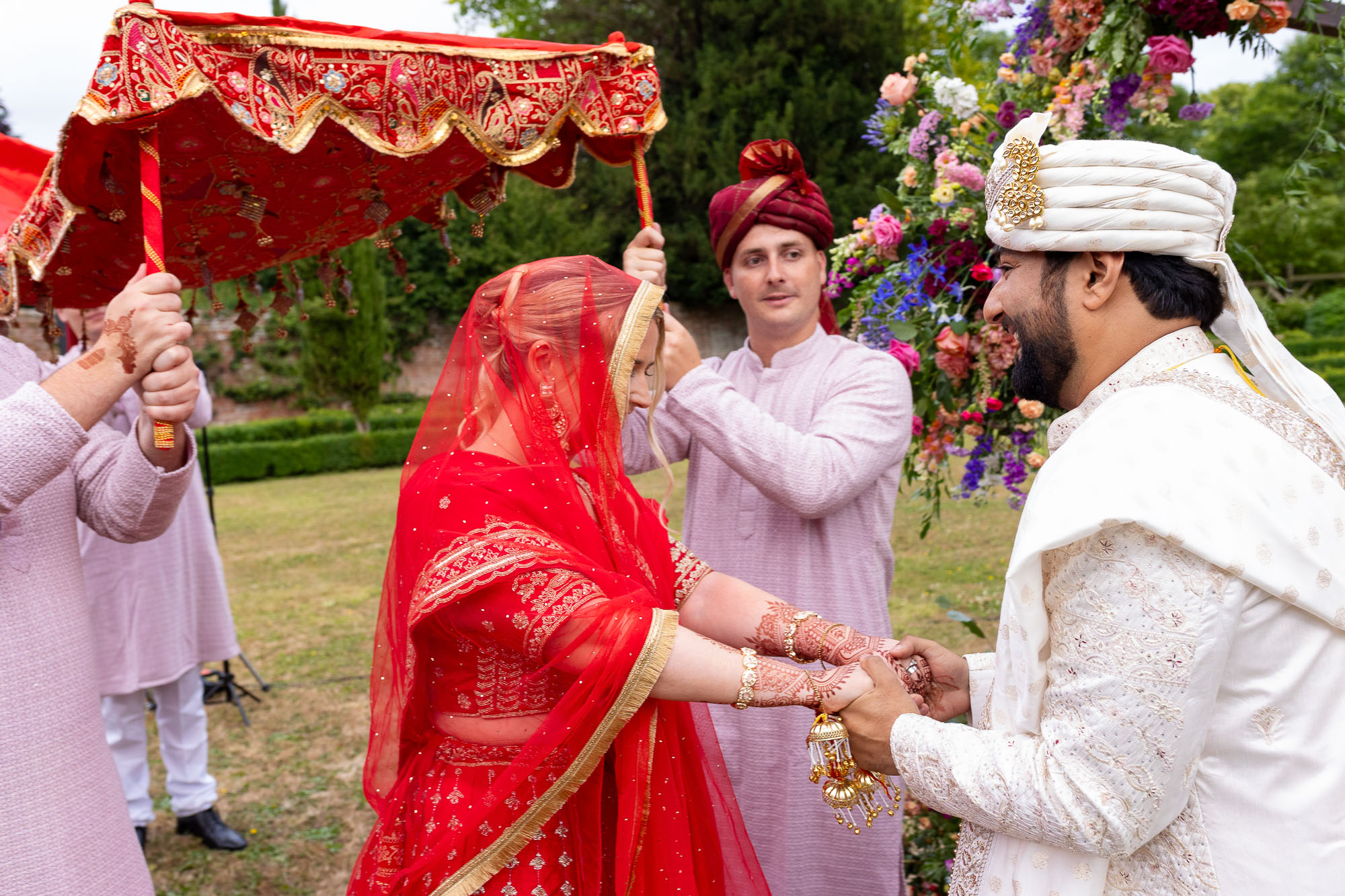 Photographs from an Indian wedding at Brympton House with really colourful flowers and a focus on human connection and love. By Martin Dabek Photography from Bristol