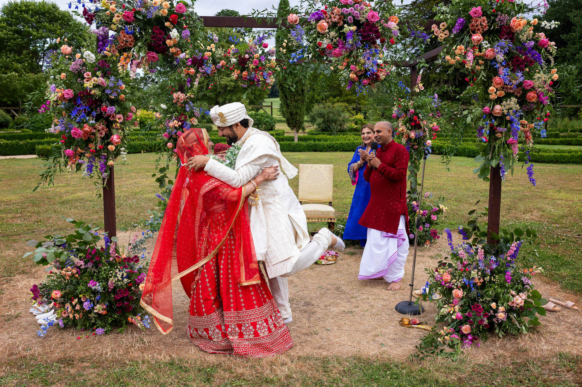 Photographs from an Indian wedding at Brympton House with really colourful flowers and a focus on human connection and love. By Martin Dabek Photography from Bristol
