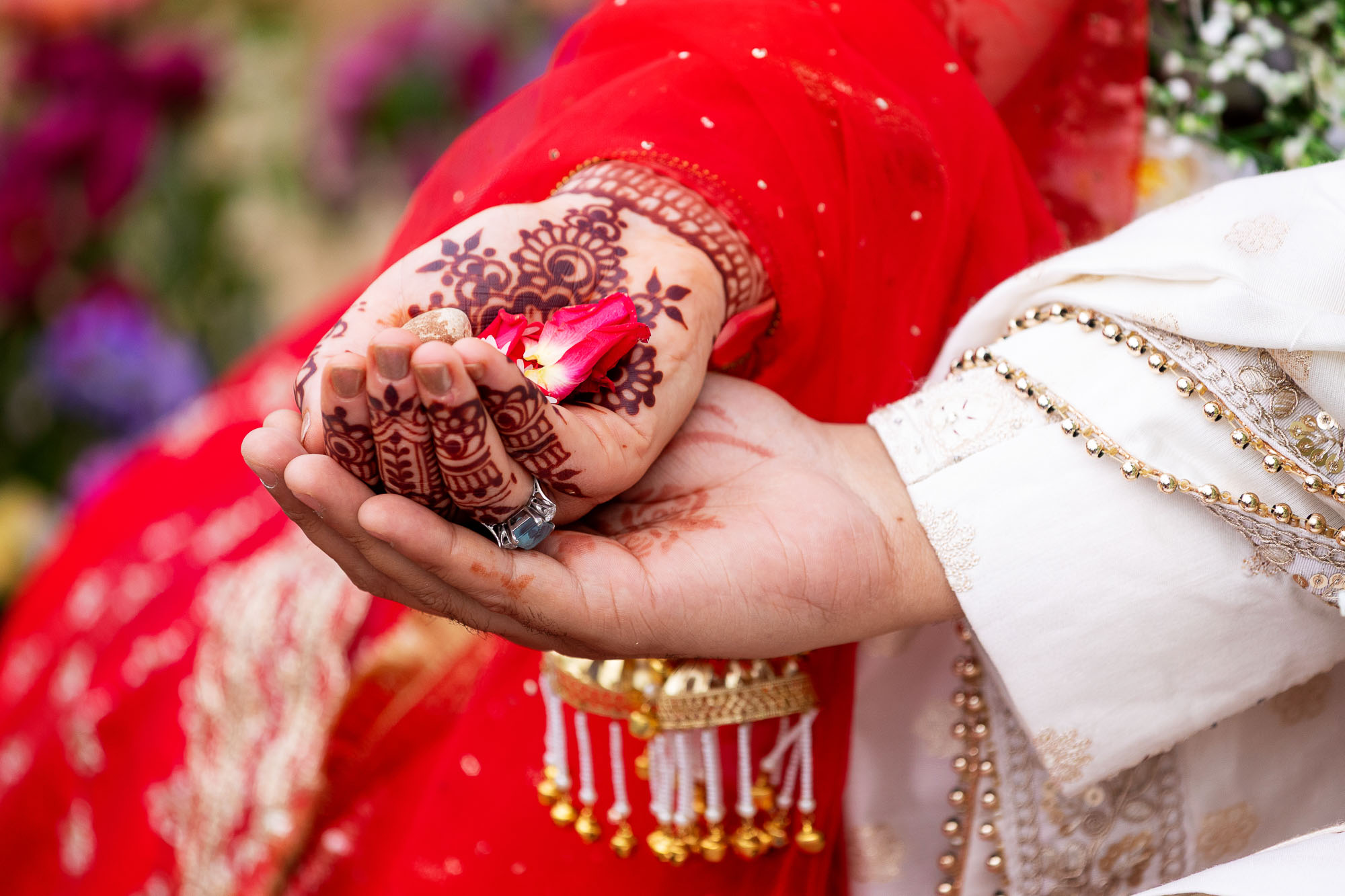 Photographs from an Indian wedding at Brympton House with really colourful flowers and a focus on human connection and love. By Martin Dabek Photography from Bristol