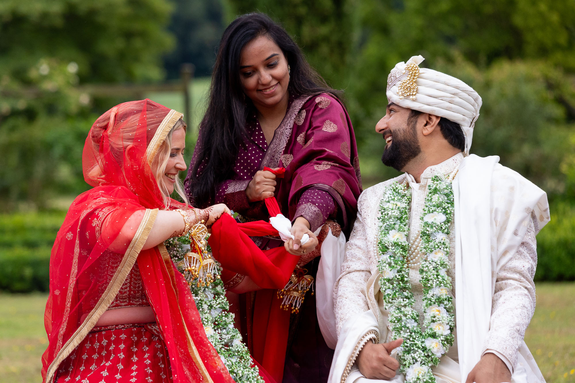 Photographs from an Indian wedding at Brympton House with really colourful flowers and a focus on human connection and love. By Martin Dabek Photography from Bristol