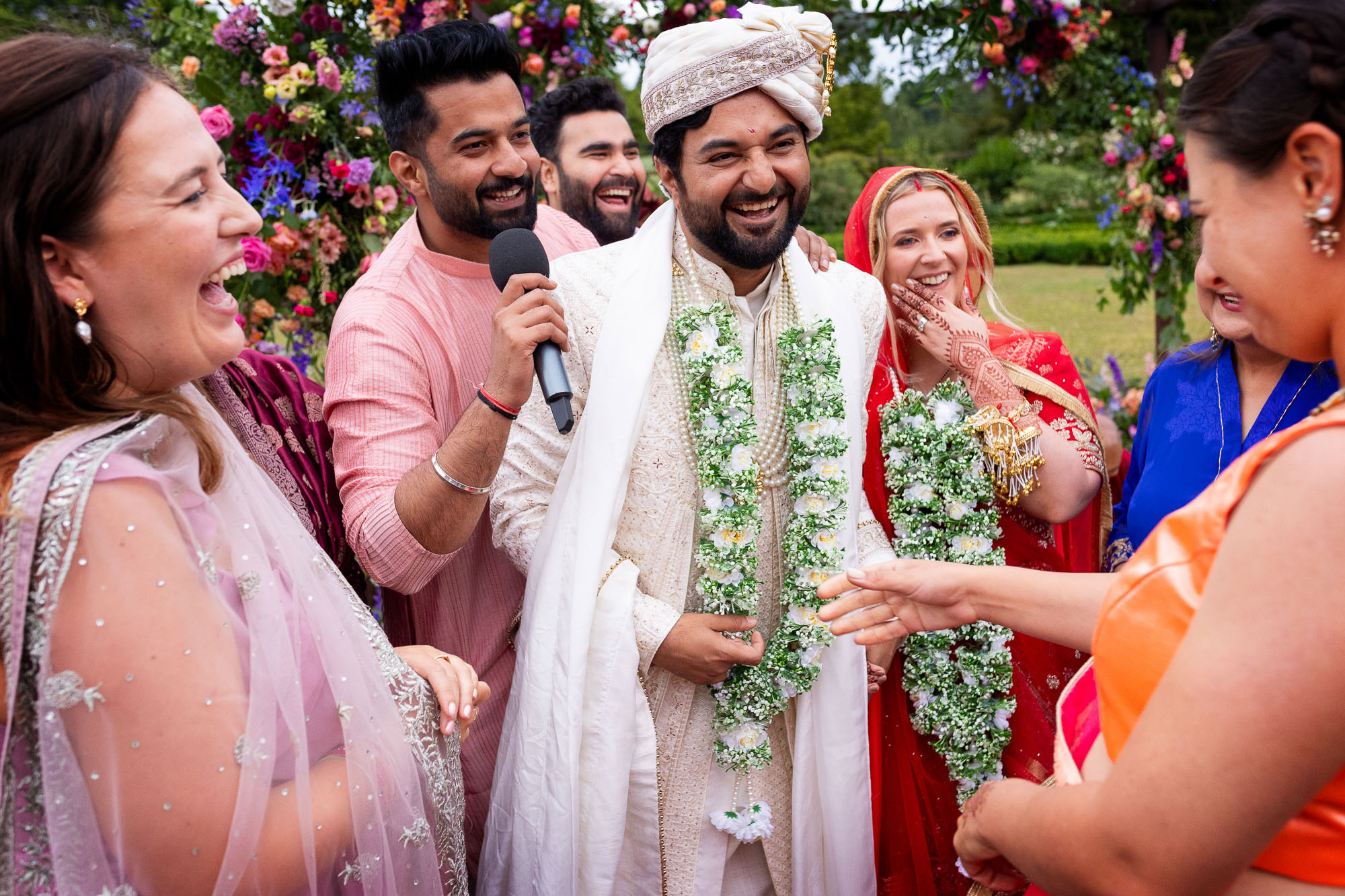 Photographs from an Indian wedding at Brympton House with really colourful flowers and a focus on human connection and love. By Martin Dabek Photography from Bristol