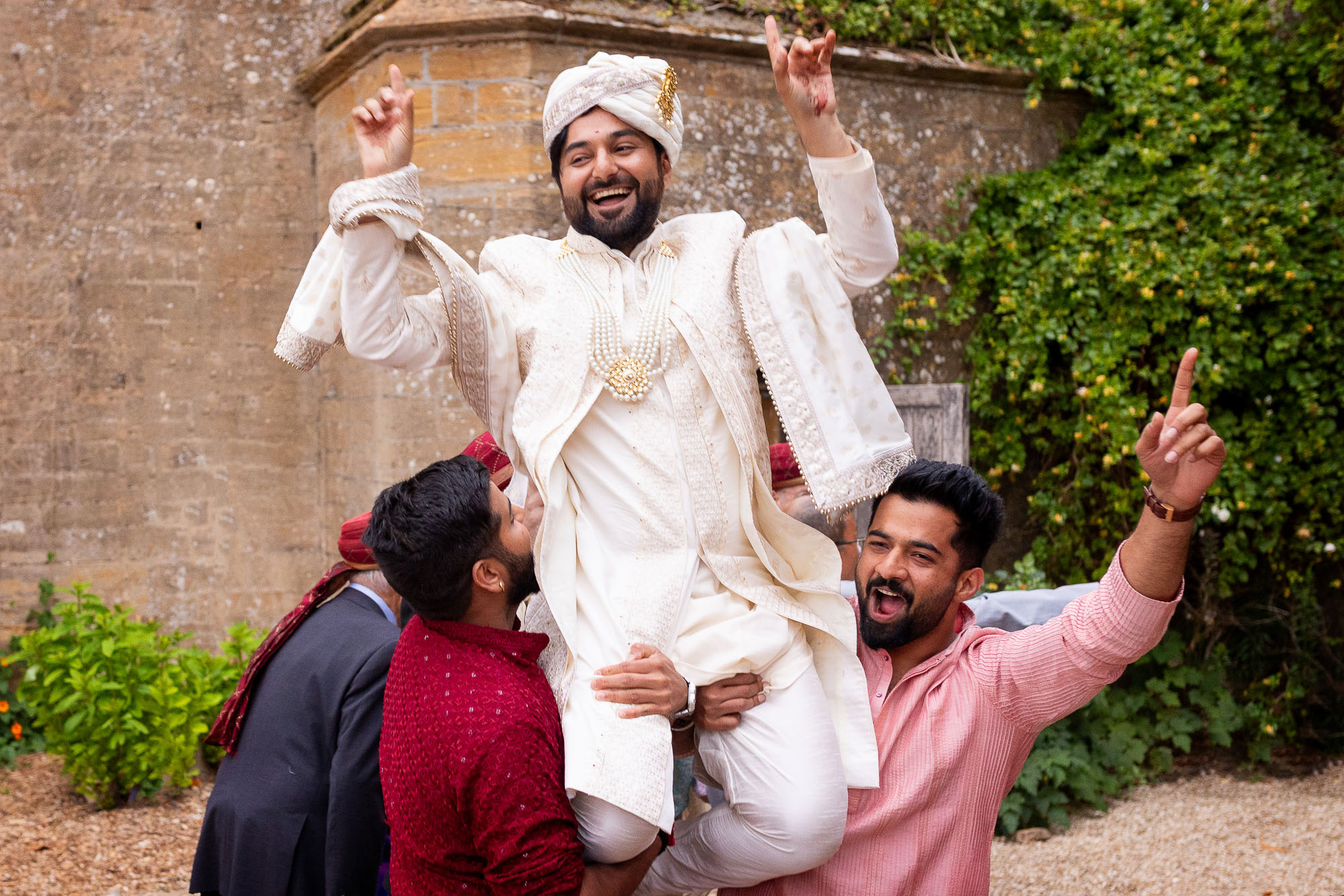 Photographs from an Indian wedding at Brympton House with really colourful flowers and a focus on human connection and love. By Martin Dabek Photography from Bristol