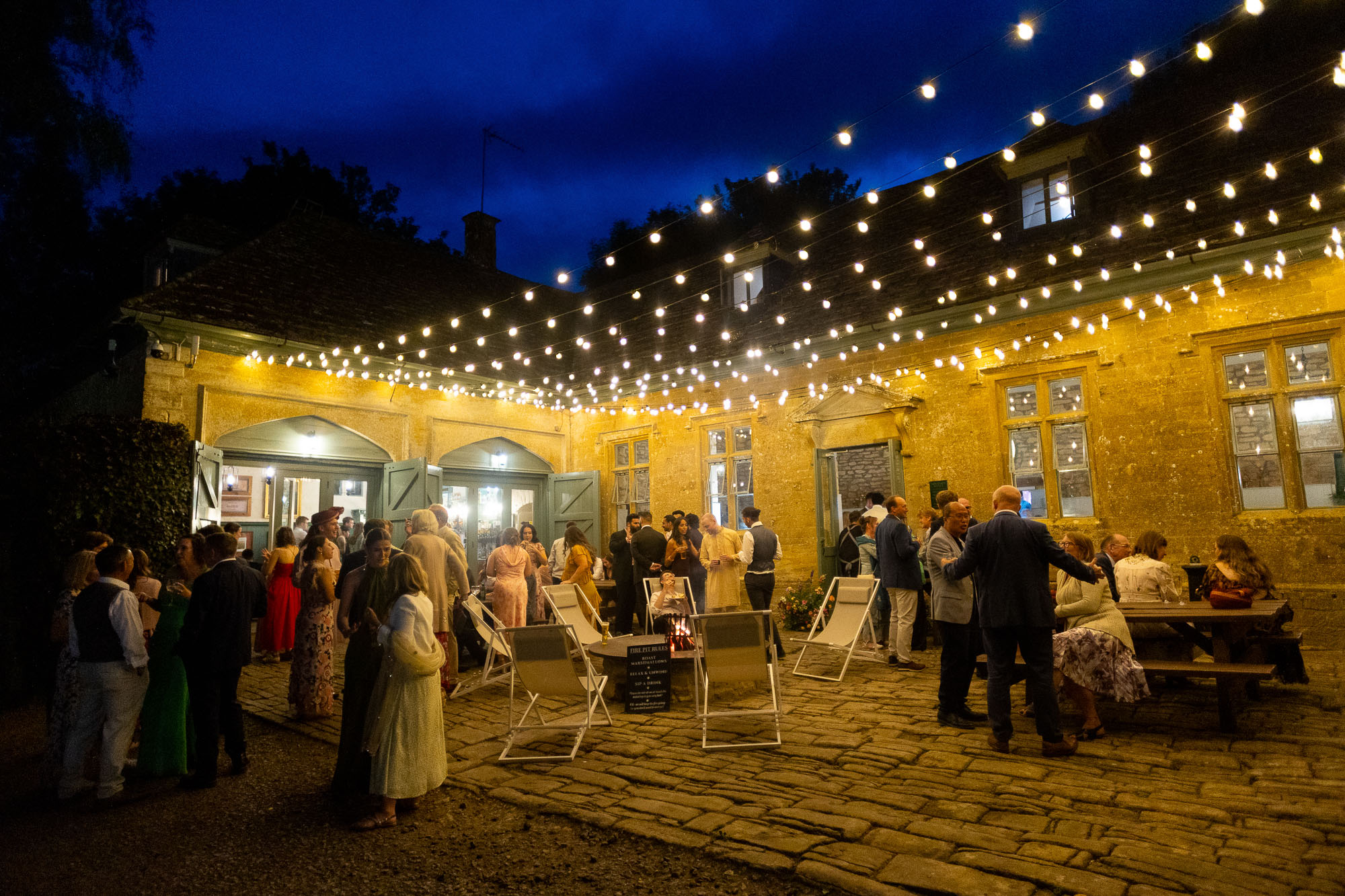 Photographs from an Indian wedding at Brympton House with really colourful flowers and a focus on human connection and love. By Martin Dabek Photography from Bristol