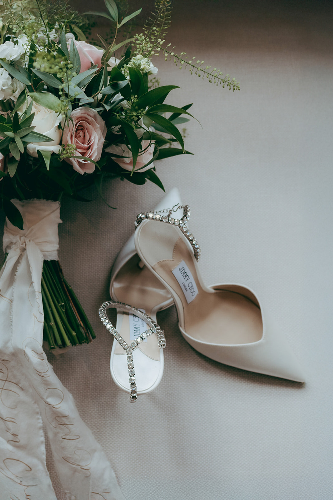 Beautifully photographed bridal shoes and bouquet by Damien Vickers Photography