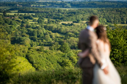 Groom and bride looking out over acres of beautiful Kent countryside - Benjamin Toms Photography | Kent