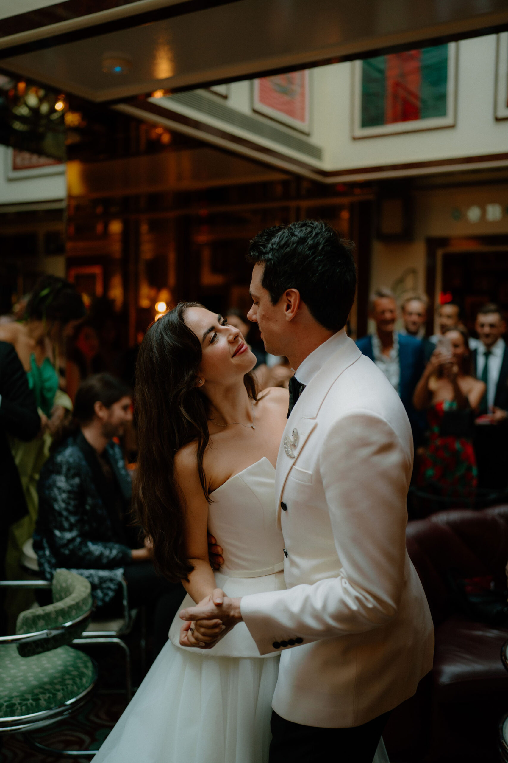 Groom and bride dancing together and looking into each other's eyes - by London documentary wedding photographer Tom Aizenberg