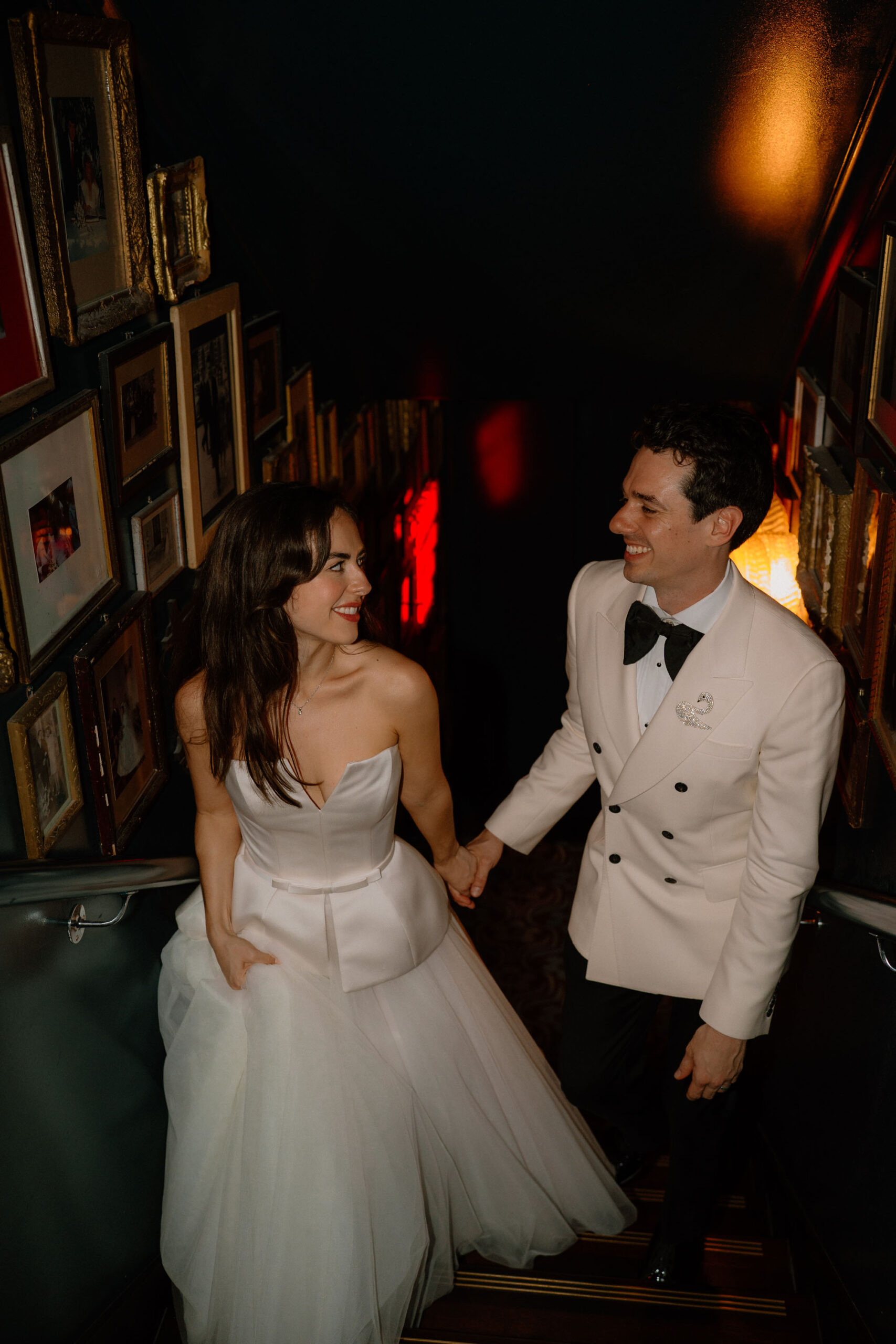 Newlyweds walking hand in hand by London documentary wedding photographer Tom Aizenberg