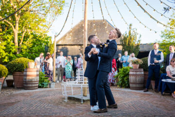 Two grooms dance and laugh at their Preston Court wedding - Benjamin Toms Photography | Kent