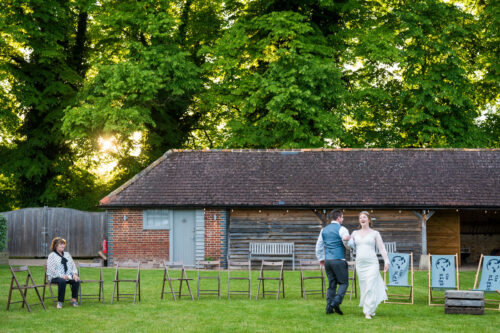 Groom and bride dance as a wedding guest watches - Benjamin Toms Photography | Kent