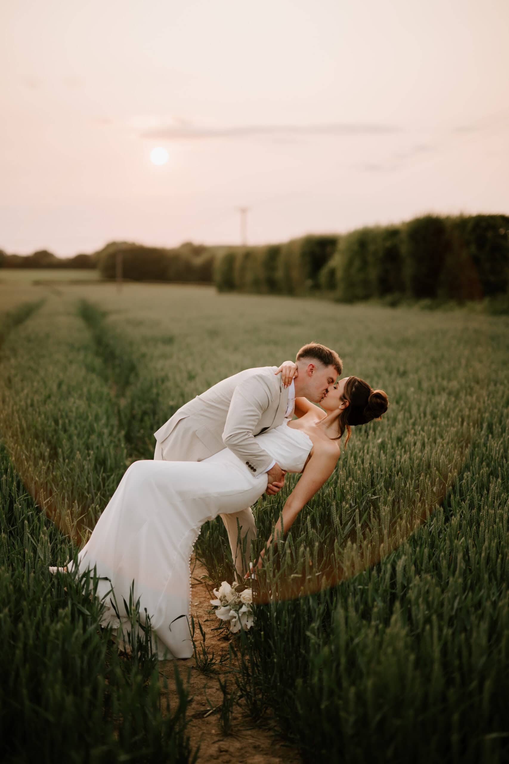 Romantic newlyweds portrait in open countryside at The Old Kent Barn with Pearce Wedding Photography