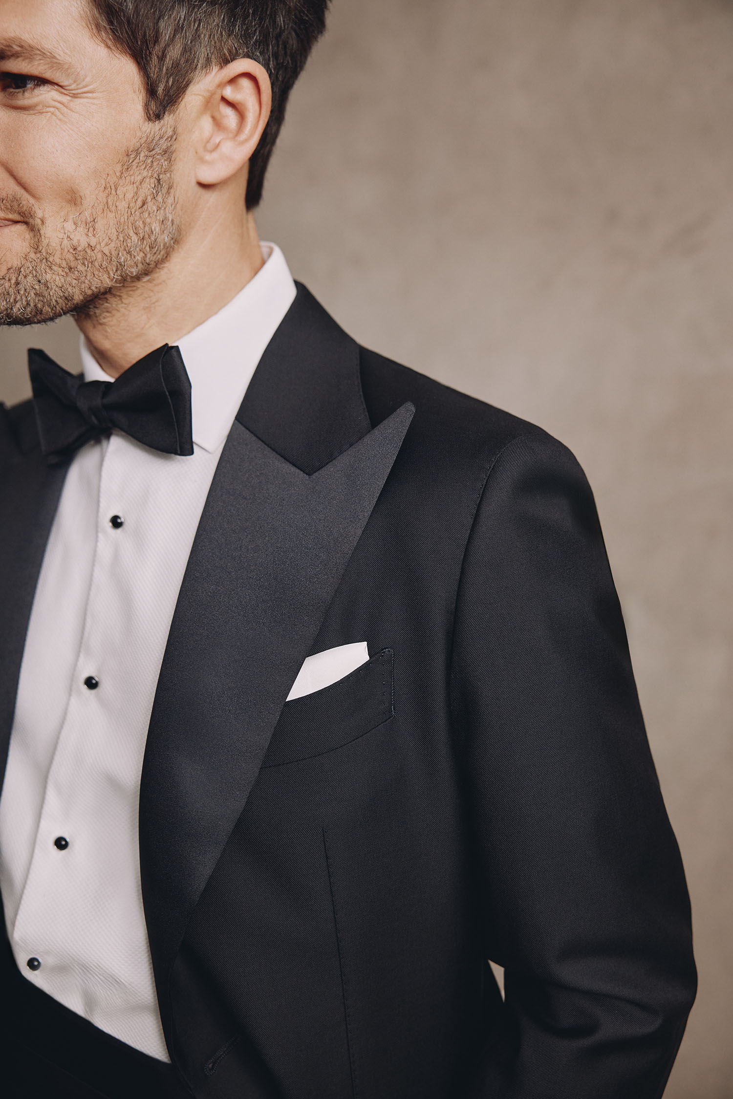 Close up of a man wearing a wedding suit with bow tie by MOSS