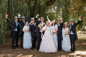 newlyweds and their wedding party in traditional hired top hats and tails by Wiltshire wedding photographer Greg Shingler