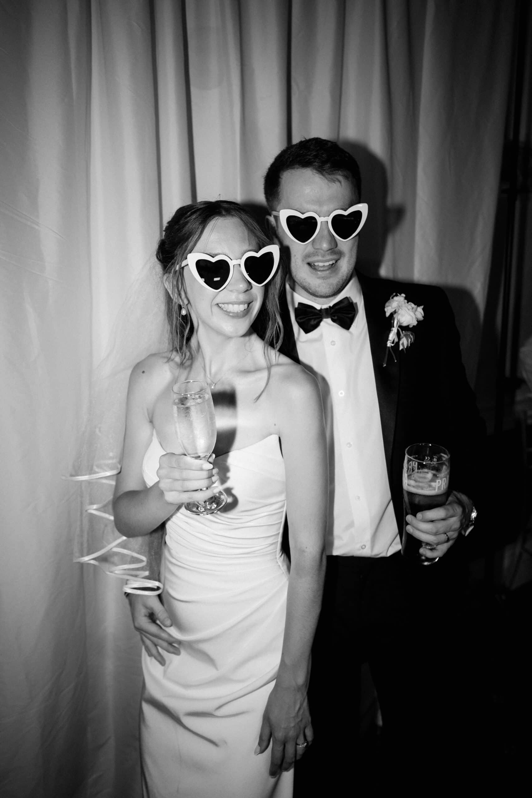 Groom and bride in heart sunglasses | black and white wedding photography by James Pearce from Kent