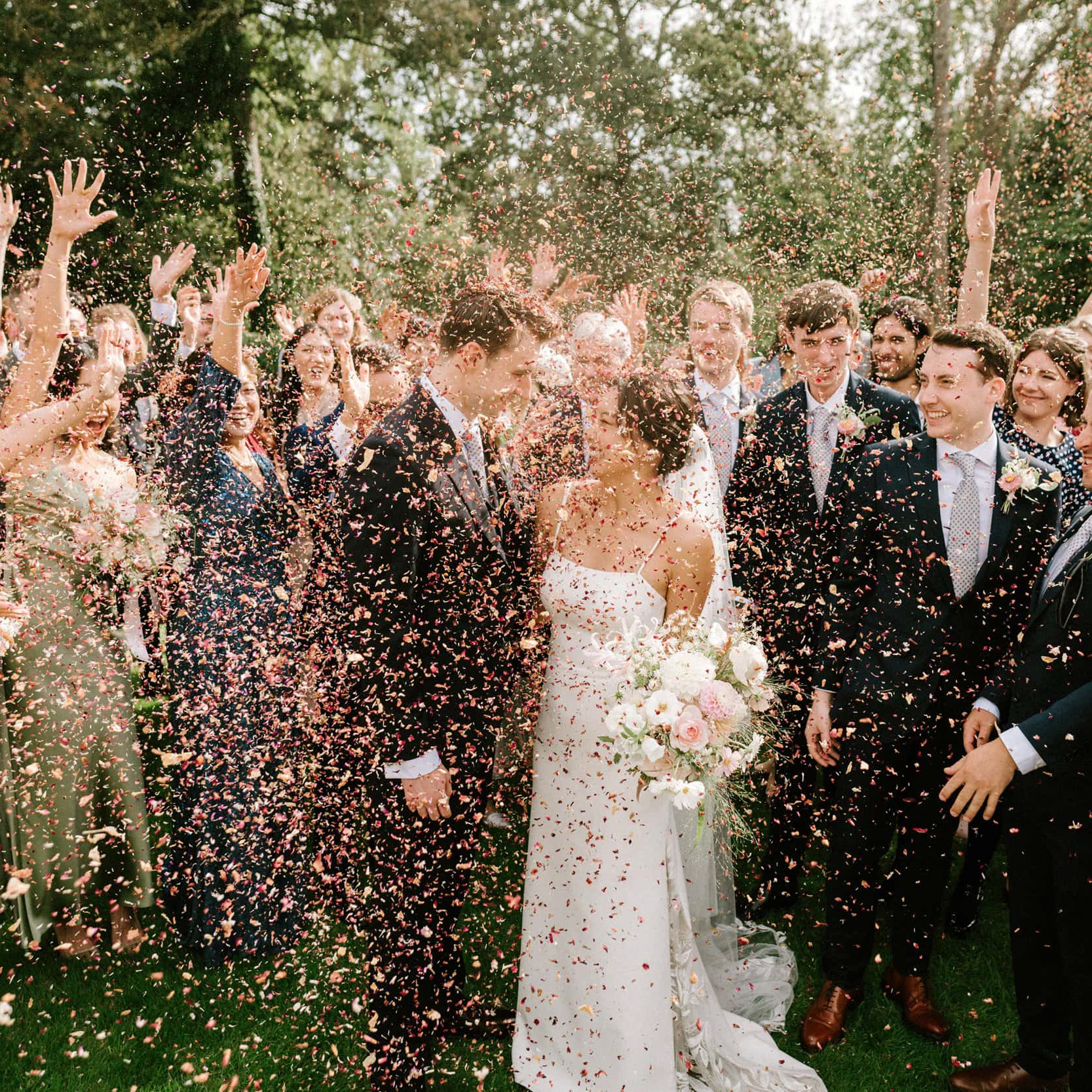 Confetti moment at Port Lympne with a couple surrounded by friends and family - relaxed documentary style by Pearce Wedding Photography