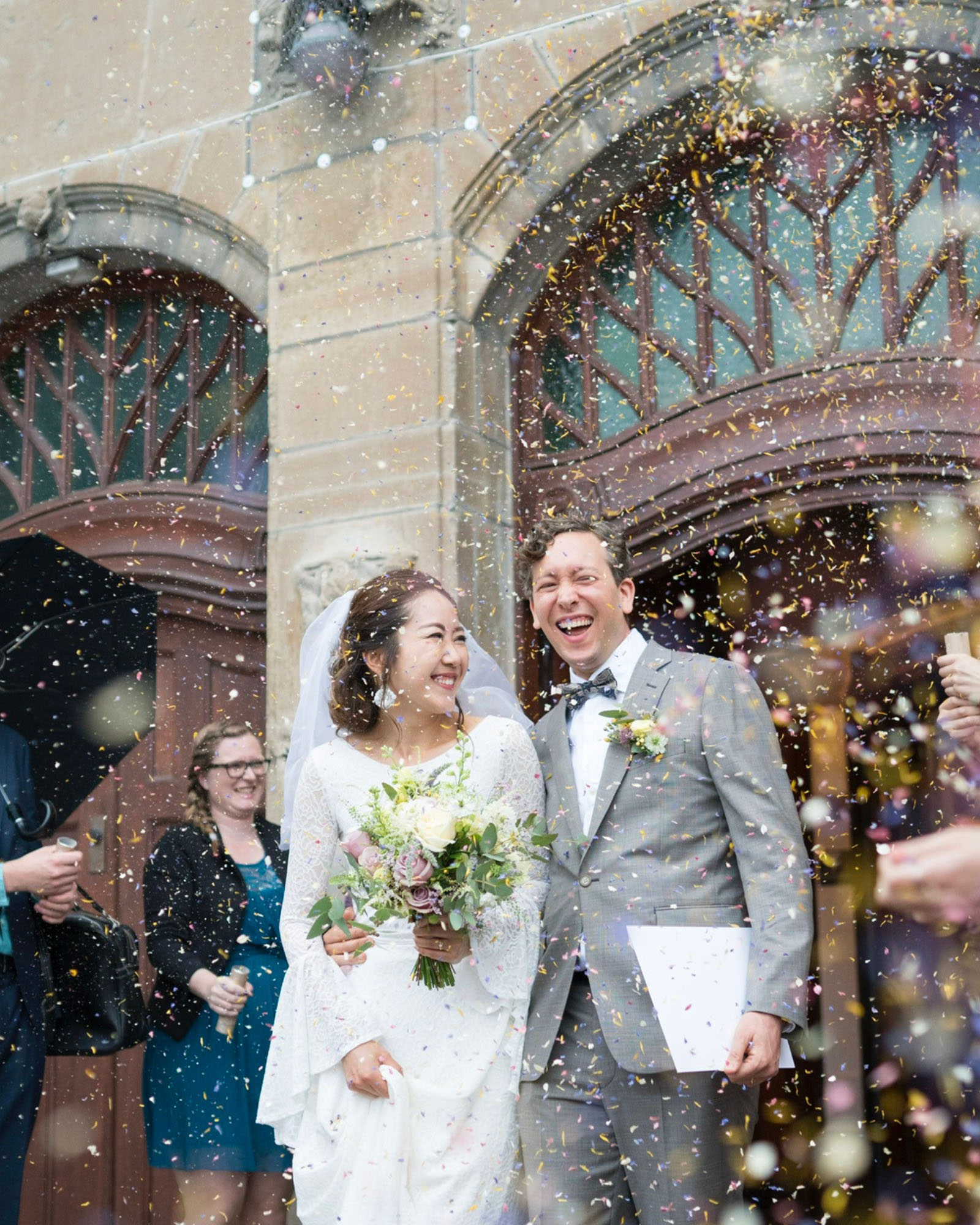 Real wedding confetti moment dried petal confetti UK | The Dried Petal Company and Erikograph Photography