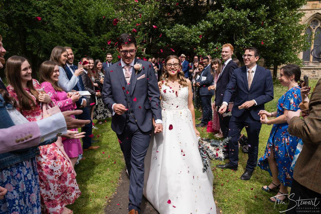 newlyweds enjoying a shower of biodegradable confetti from The Dried Petal Company UK nationwide Tim Stewart Photography
