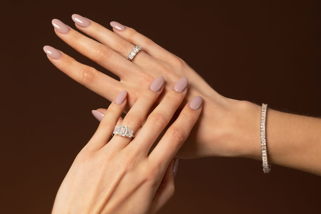 Hands close up showing engagement ring, bracelet and ring | Hatton Jewels in London