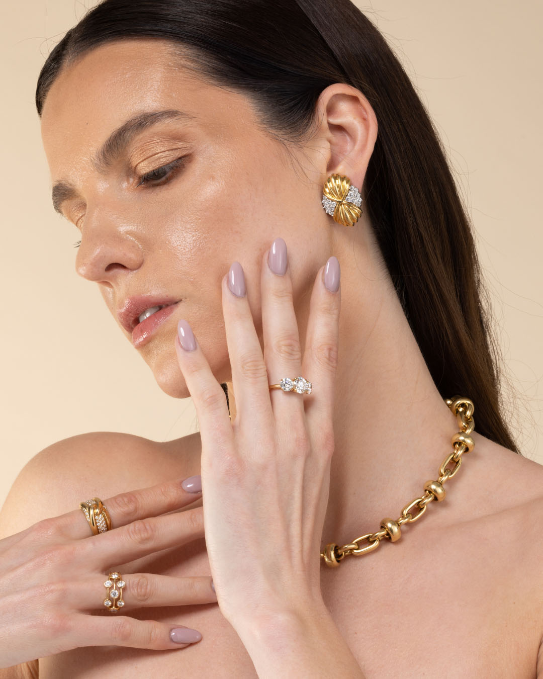 Model wearing rings, necklace and statement earrings | Hatton Jewels in London