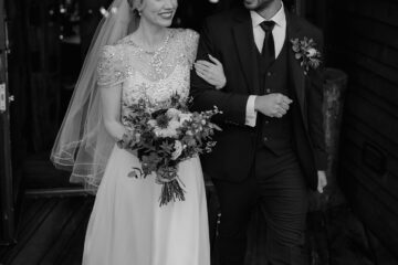 Newlywed couple walking arm in arm at Alnwick Treehouse | North Yorkshire wedding photographer Joss Denham