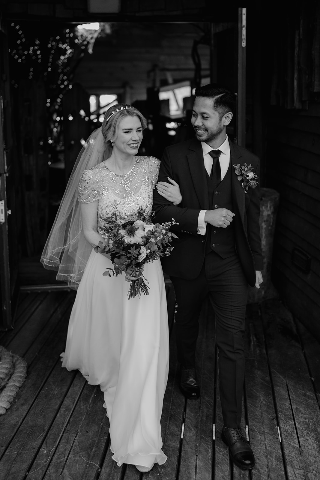 Newlywed couple walking arm in arm at Alnwick Treehouse | North Yorkshire wedding photographer Joss Denham