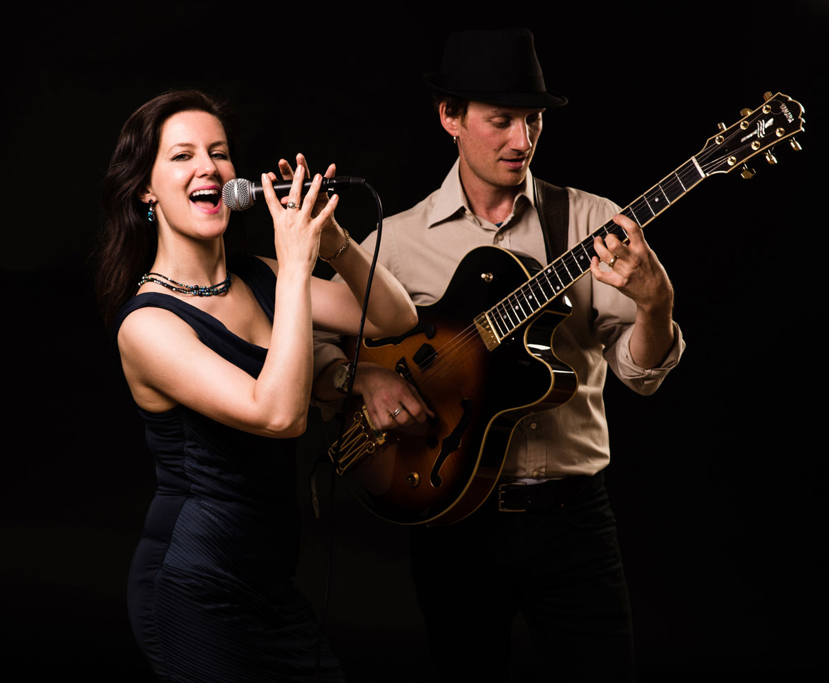 Vocalist with microphone and backing guitarist | Last Minute Musicians wedding entertainment agency UK wide