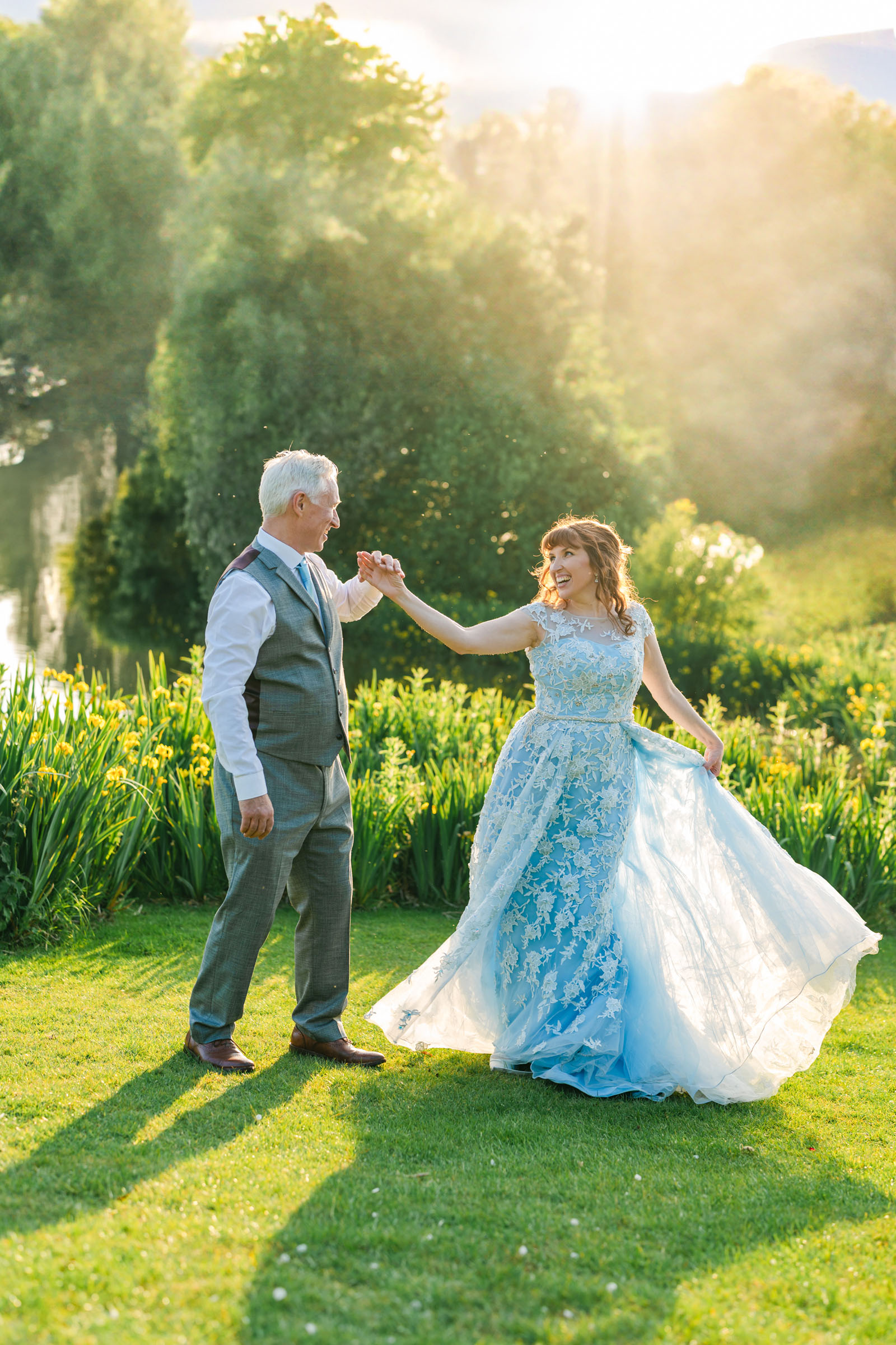 Groom and bride dancing in a field at golden hour | credit Christy Photography at Sandhole Oak Barn Cheshire