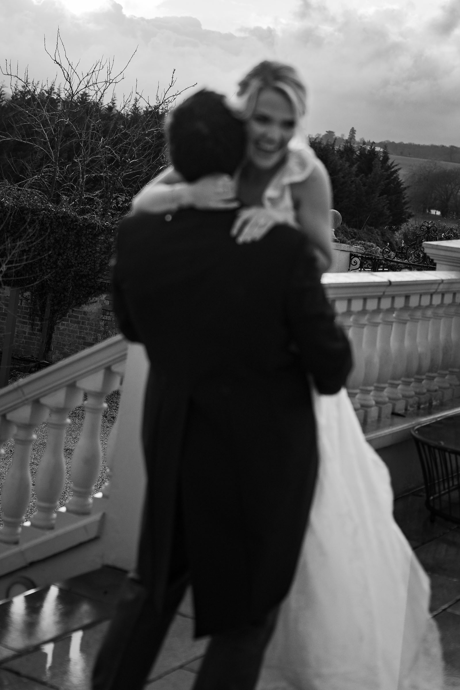 Model couple embrace - she's wearing a wedding dress and he's in a suit - styled photoshoot by Lauren Batten Events