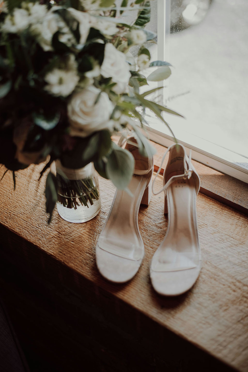 wedding bouquet and bridal shoes by Katelyn MacMillan on Unsplash